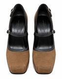 A pair of Mary Jane platform heels in brown suede and black leather, shown from a top-down view on a white background.