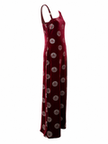 A sleeveless, floor-length halter dress in deep burgundy velvet with an allover circular medallion pattern, shown against a plain white background.