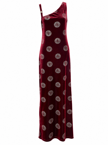 A one-shoulder velvet maxi dress in deep burgundy red, featuring a repeating circular gold and silver pattern, shown against a plain white background.