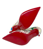 A pair of CL pointed-toe high heels with glossy bright red soles and multicolor patterned uppers, photographed on a plain white background.