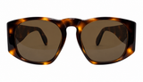 Oversized square sunglasses with a glossy tortoiseshell frame in brown and amber tones, paired with dark brown tinted lenses, shown against a plain white background.