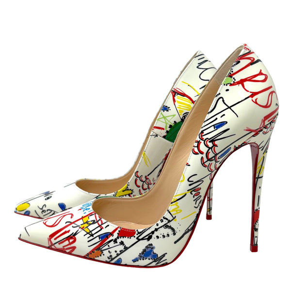 A pair of pointed-toe stiletto pumps featuring a white base covered in a colorful graffiti-style abstract scribble print, with a signature red outsole visible on a plain white background.