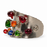 A wide silver cuff bracelet featuring multiple colorful teardrop-shaped gemstones in red, green, orange, blue, and purple, set against a plain white background.