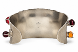 A Gucci wide silver cuff bracelet with organic wavy edges, featuring red and amber gemstone accents on the outer flanges, photographed on a white background.