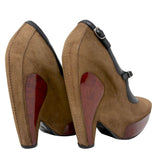 A pair of Balenciaga women's high-heeled shoes shown from the back, featuring a brown suede upper, black ankle straps with silver buckles, and glossy dark red patent leather heel inserts on a white background.
