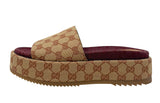 A single Gucci platform slide sandal featuring the classic GG  monogram canvas in beige and brown, with a burgundy velvet insole and a textured brown rubber sole.