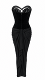 Black strapless gown with a draped skirt on a white background