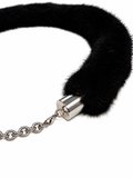 A close-up of a black faux-fur collar or choker with a silver metal cylindrical clasp and chain extension, shown on a plain white background.