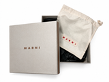 A luxury gift set by Marni, featuring a textured beige presentation box with the brand name embossed, an open inner box with black tissue paper, and a beige drawstring dust bag with a red embroidered MARNI logo.
