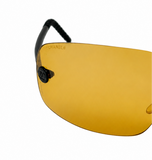 A close-up of Chanel shield-style sunglasses with a yellow-tinted lens and black temple arm, shown on a plain white background.