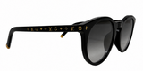 Louis Vuitton sunglasses with a glossy black acetate frame, featuring the brand's signature gold monogram pattern on the temples and gradient gray lenses.